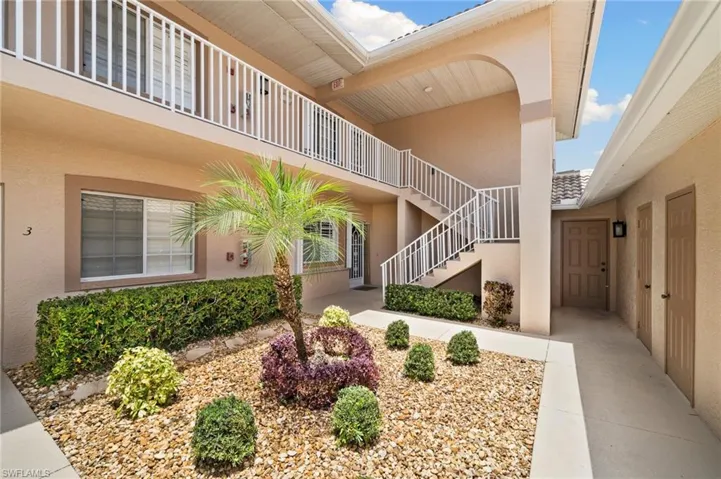 View of exterior entry with a balcony