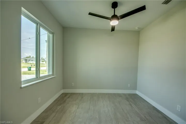 Spare room featuring ceiling fan and light wood-type flooring