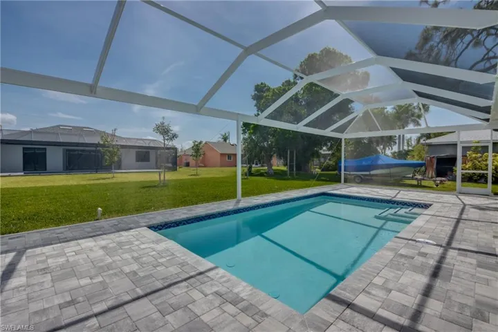 View of pool with a lawn, a lanai, and a patio area
