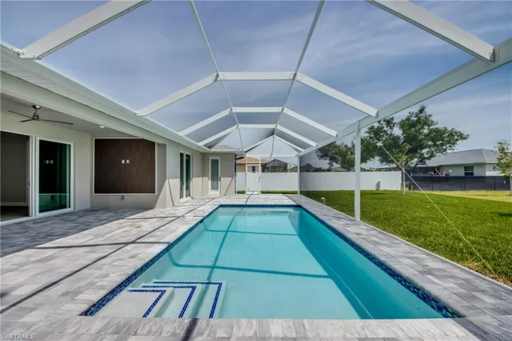 View of pool featuring a patio and a lawn