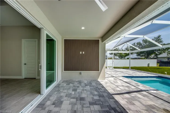 View of pool with a lanai and a patio