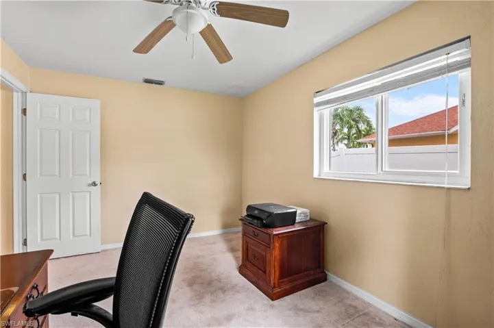 Office featuring light colored carpet and ceiling fan