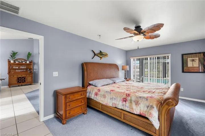 Bedroom with ceiling fan and light tile patterned floors