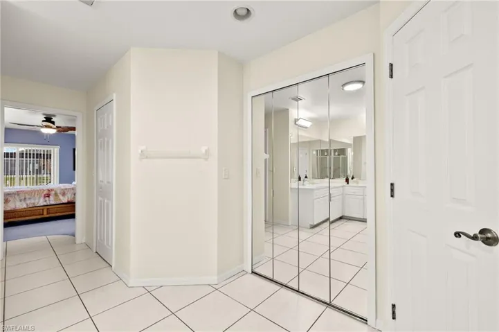 Hall featuring light tile patterned flooring and sink