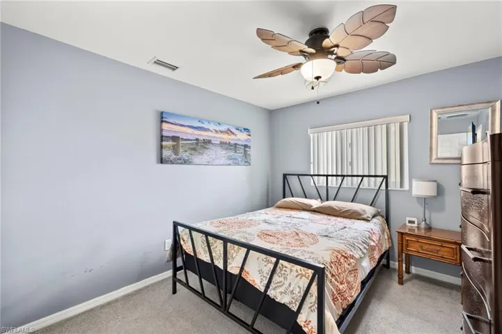 Carpeted bedroom with ceiling fan
