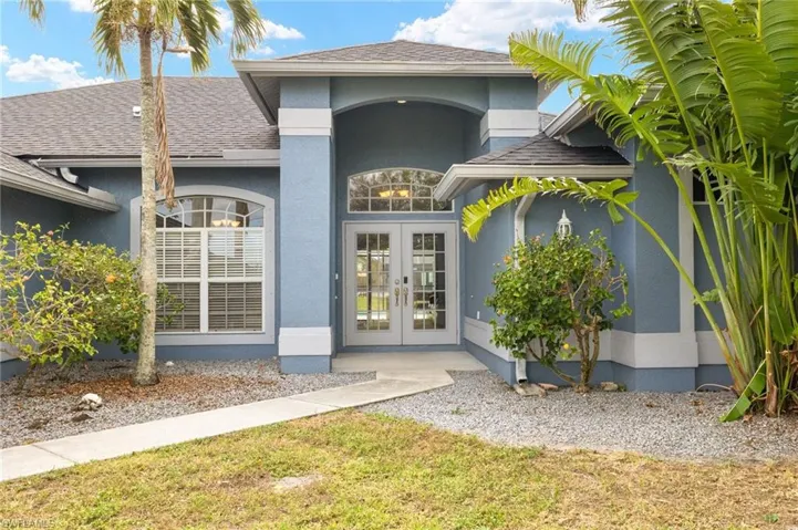 Doorway to property featuring french doors and a yard