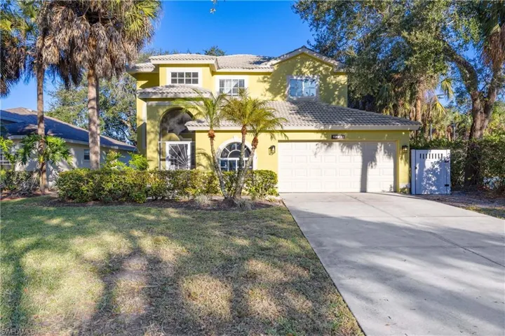 Mediterranean / spanish home featuring a tiled roof, stucco siding, driveway, and an attached garage