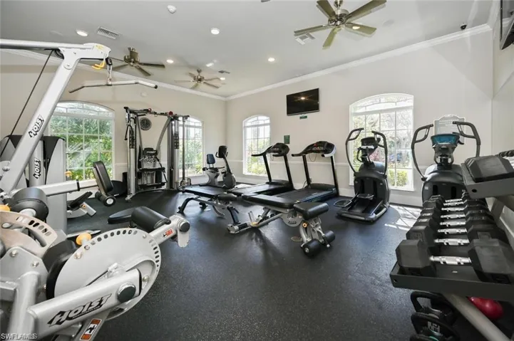 Workout area featuring ornamental molding and recessed lighting
