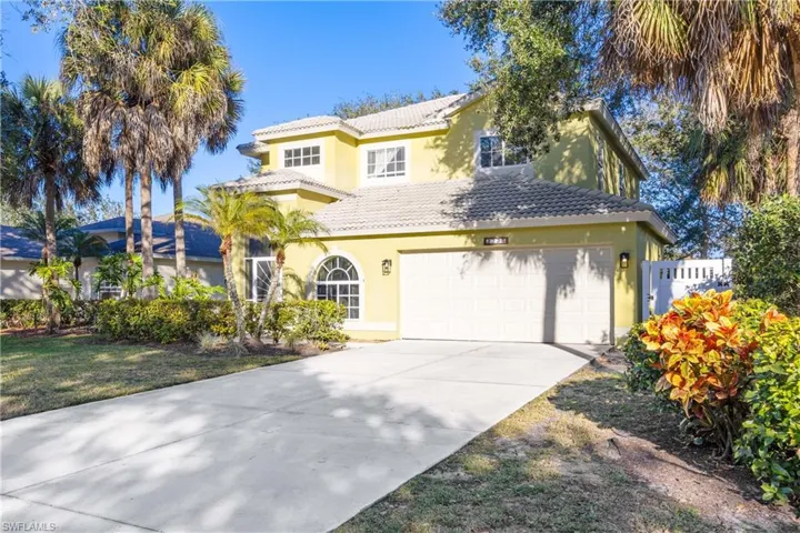Mediterranean / spanish house with stucco siding, a tiled roof, driveway, and a garage