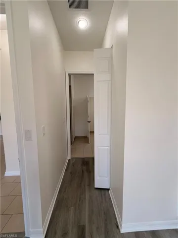 Recessed lighting illuminating wood-finish flooring