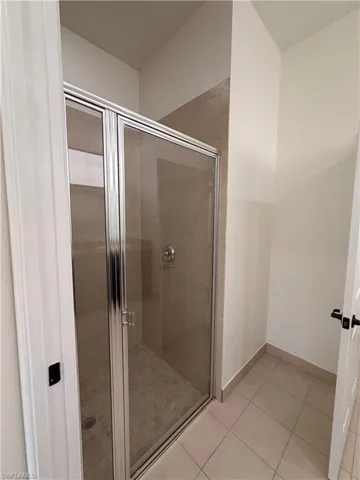 Enclosed shower with clear glass door and brushed nickel hardware