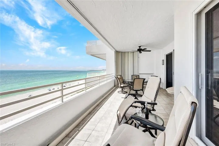 Balcony featuring a view of the beach