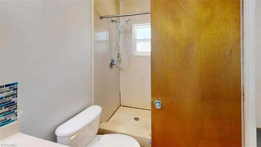 Full bath featuring a stall shower and vanity