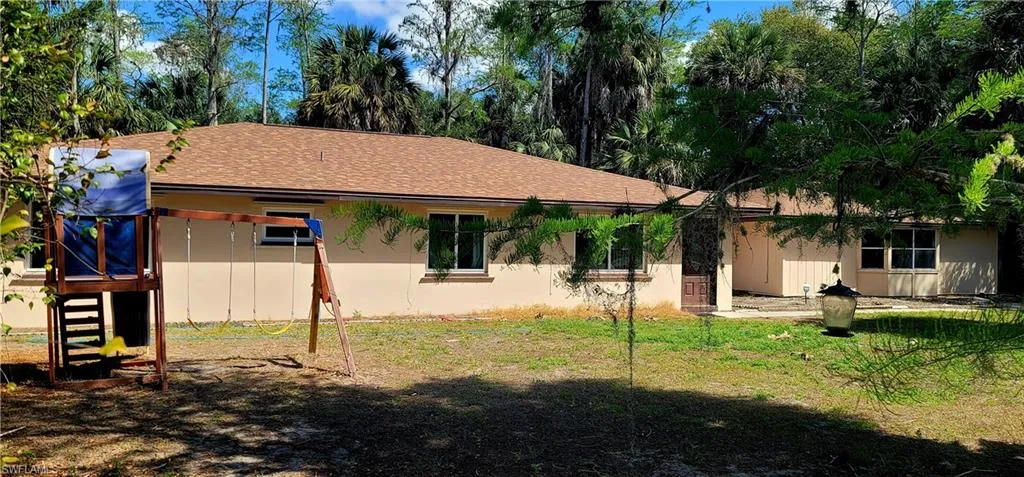 front of property featuring a shingled roof and a patio