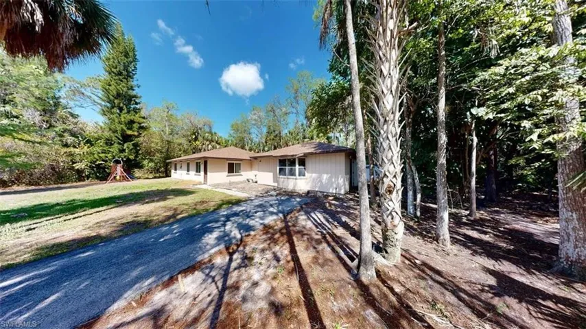 Ranch-style house featuring a playground and a front lawn