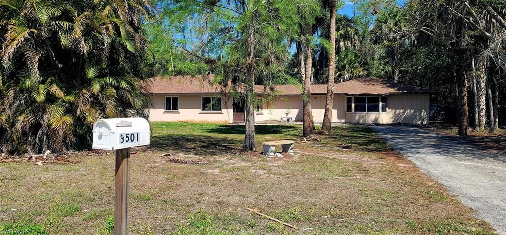 Single story home featuring a front lawn and driveway