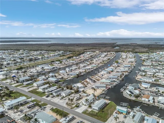Birds eye view of property with a water view