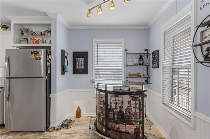 Dining room featuring light hardwood / wood-style floors, ornamental molding, and a wealth of natural light