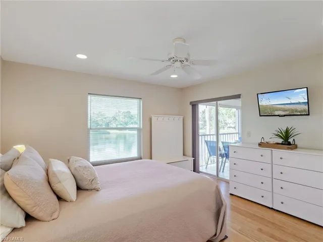 Bedroom featuring recessed lighting, light wood finished floors, a ceiling fan, and access to outside