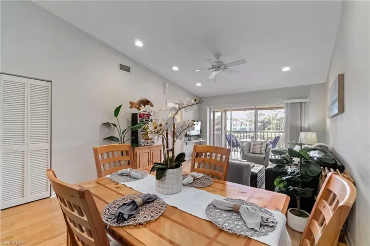 Dining area with light wood finished floors, recessed lighting, ceiling fan, and lofted ceiling