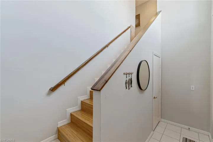 Stairway with baseboards by front entry.
