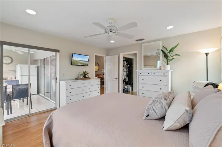 Owners Suite with sliding glass door to balcony