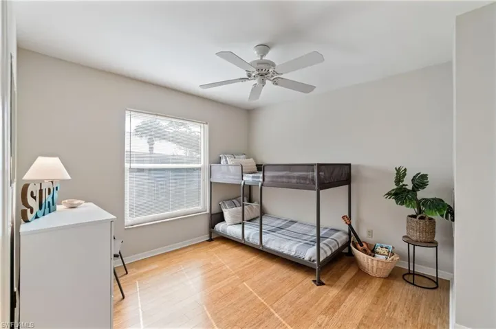 Bedroom with light wood-type flooring and a ceiling fan