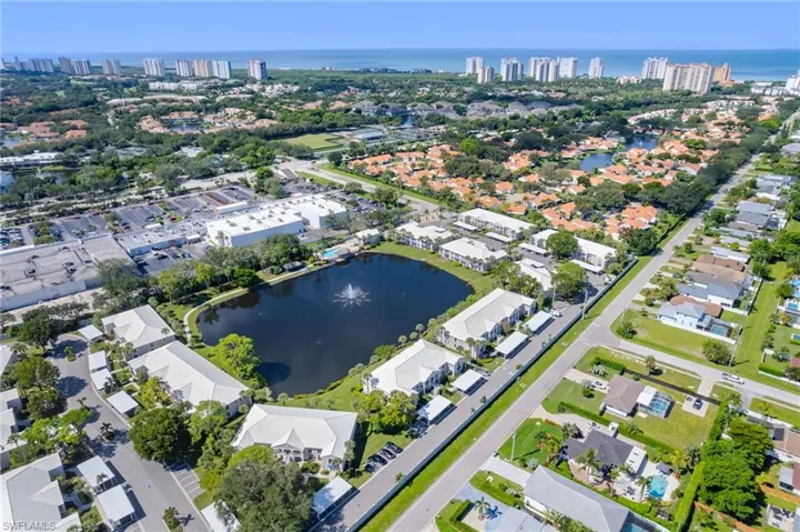 Aerial View featuring Vanderbilt Beach and nearby shopping/dining