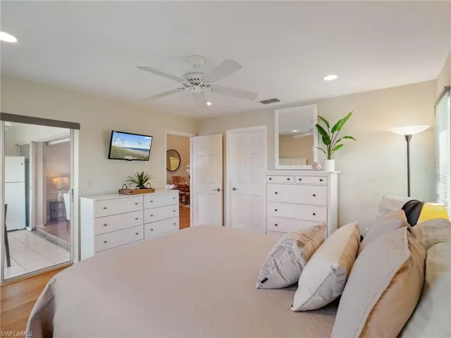 Bedroom featuring recessed lighting, freestanding refrigerator, ceiling fan, and light wood-style floors
