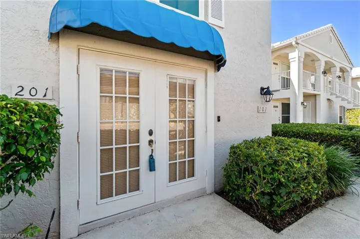 Entrance to property featuring stucco siding and french doors