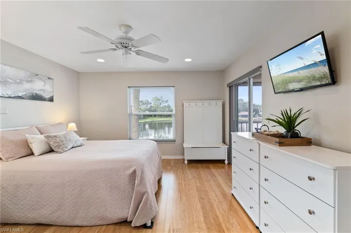 Owners Suite with walk in closet, recessed lighting, and ceiling fan