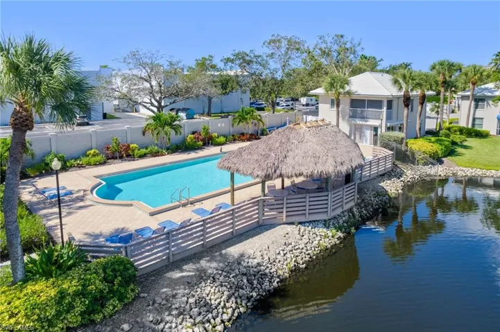 View of pool with a patio and a water view