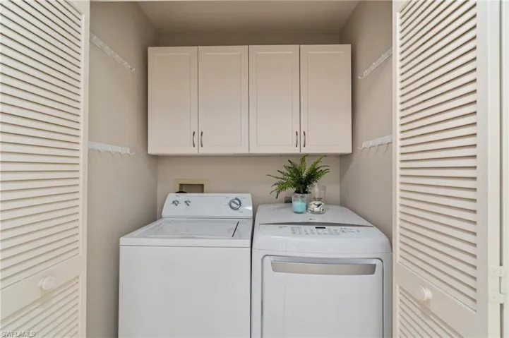 Laundry room with independent washer and dryer and cabinet space