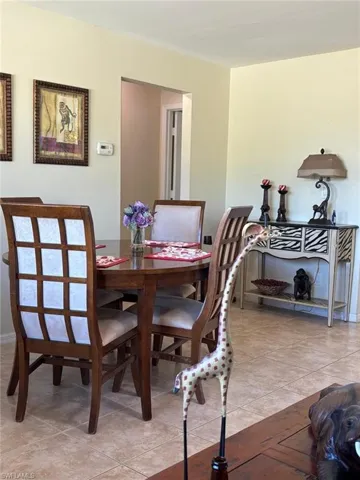 Dining area featuring light tile patterned flooring and baseboards