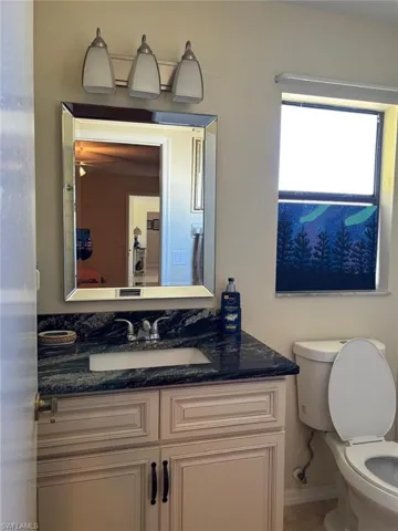 Half bathroom with vanity and toilet