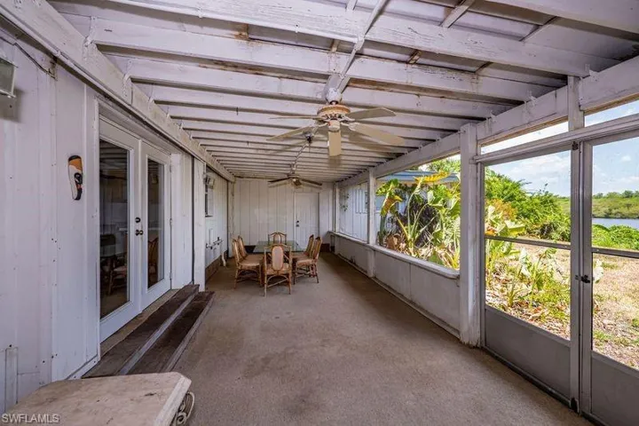 Unfurnished sunroom with ceiling fan