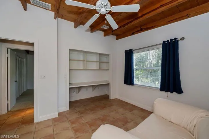 Unfurnished bedroom featuring wooden ceiling, a closet, ceiling fan, and light tile floors