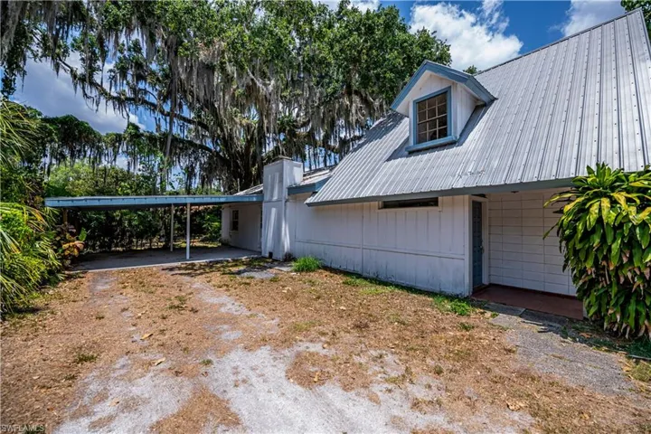 View of side of property with a carport