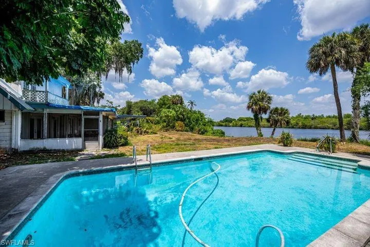 View of pool featuring a sunroom