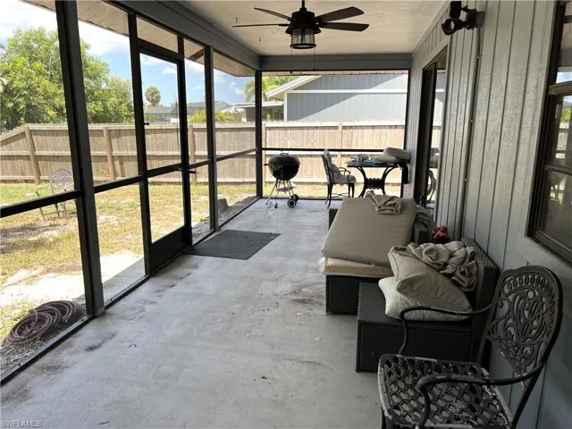 Sunroom with a healthy amount of sunlight and ceiling fan
