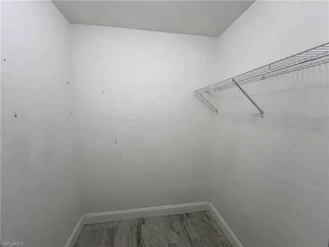 Walk in closet with tile floors