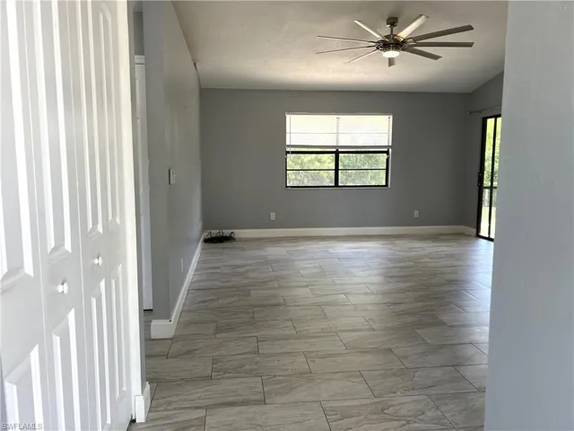 Entry featuring tile floors and ceiling fan