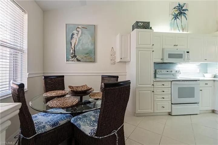 Dining space with light tile patterned floors