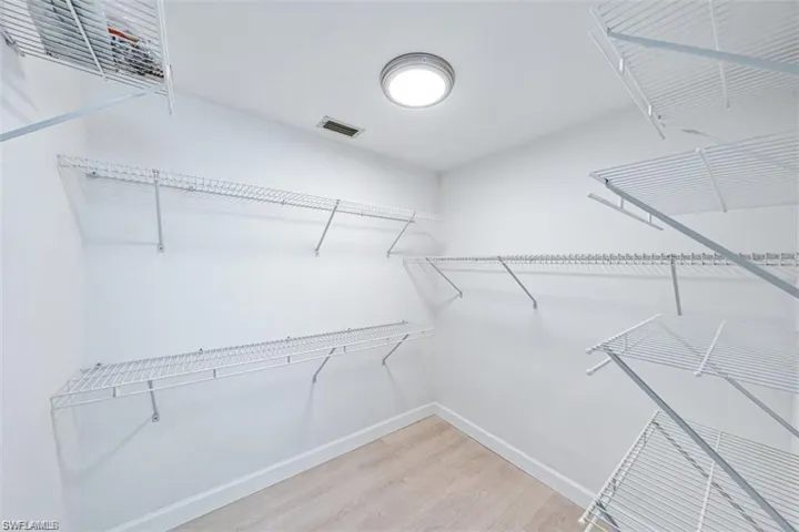 Walk in closet featuring light wood-style floors