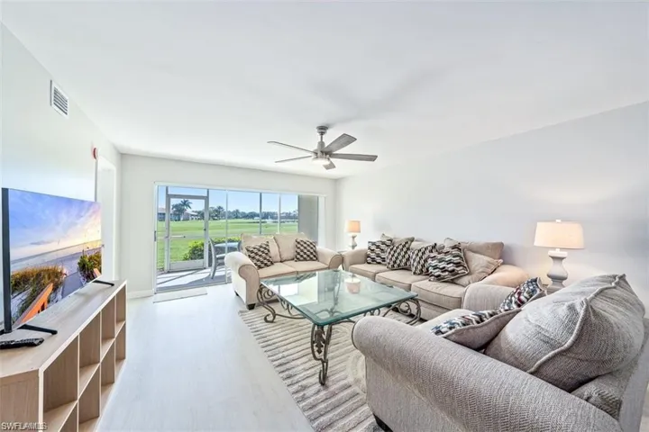 Living area with wood finished floors and a ceiling fan