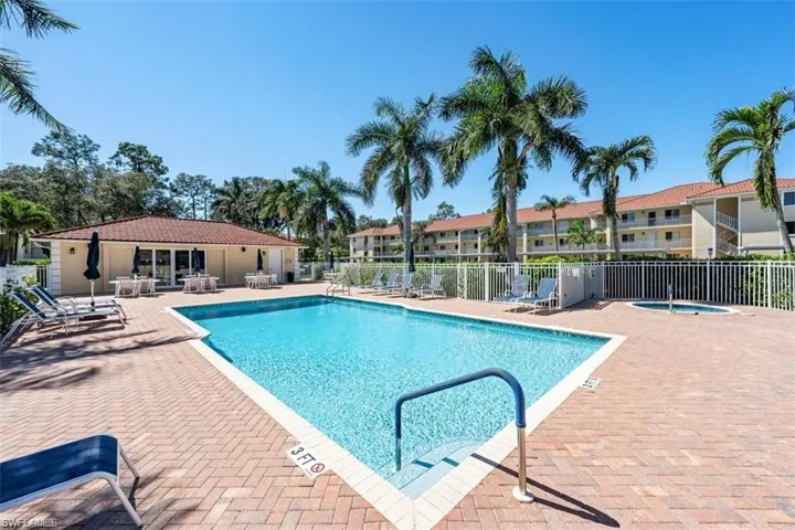 Community pool featuring a hot tub and a patio