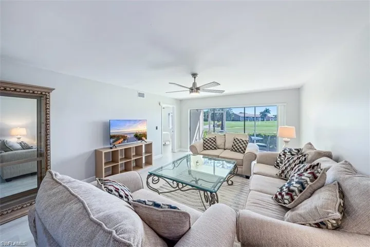 Living area with a ceiling fan and wood finished floors