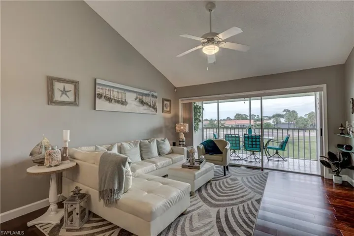 Living area with dark wood-style flooring and ceiling fan