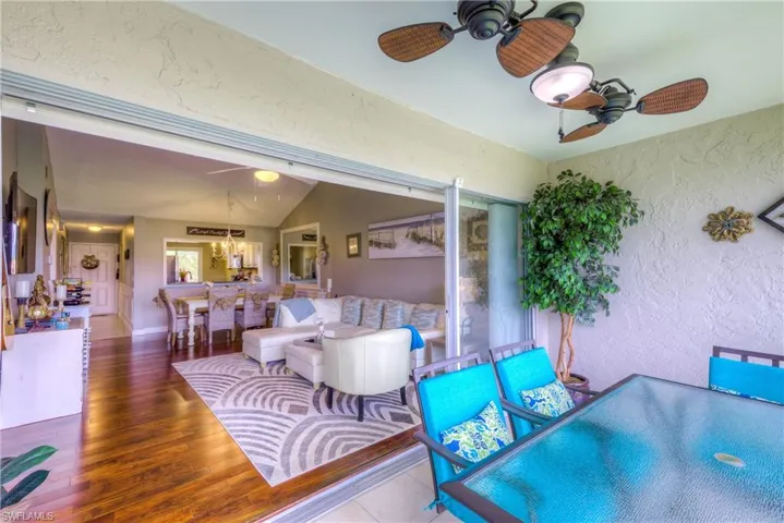 View of patio / terrace featuring a ceiling fan, a wooden deck, and an outdoor bar and dining area