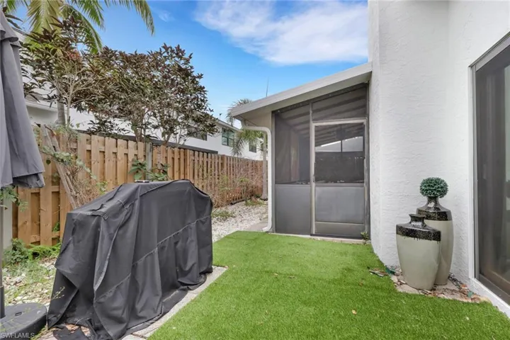 View of yard with a screened lanai